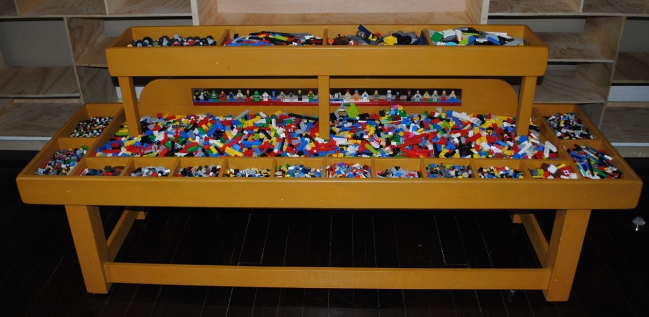 Lego table with legos filled in it.